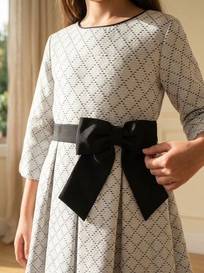 Vestido blanco con rombos negros y fajin con lazo negro