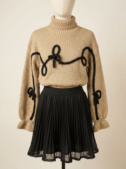 Conjunto jersey marrón con detalles negros y falda plisada negra