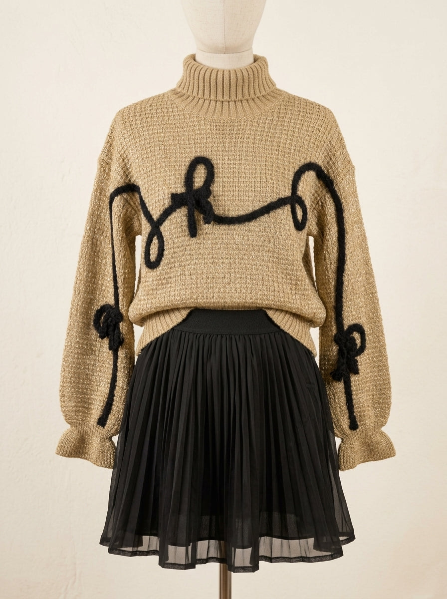 Conjunto jersey marrón con detalles negros y falda plisada negra