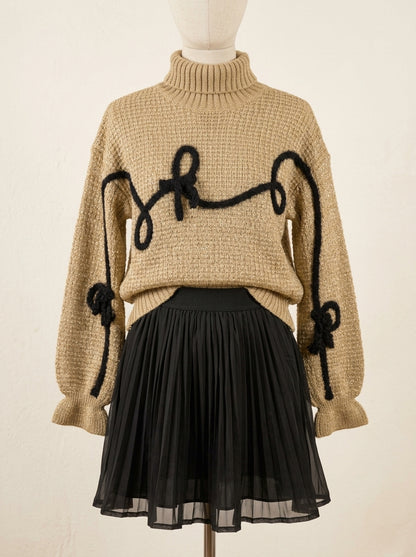 Conjunto jersey marrón con detalles negros y falda plisada negra