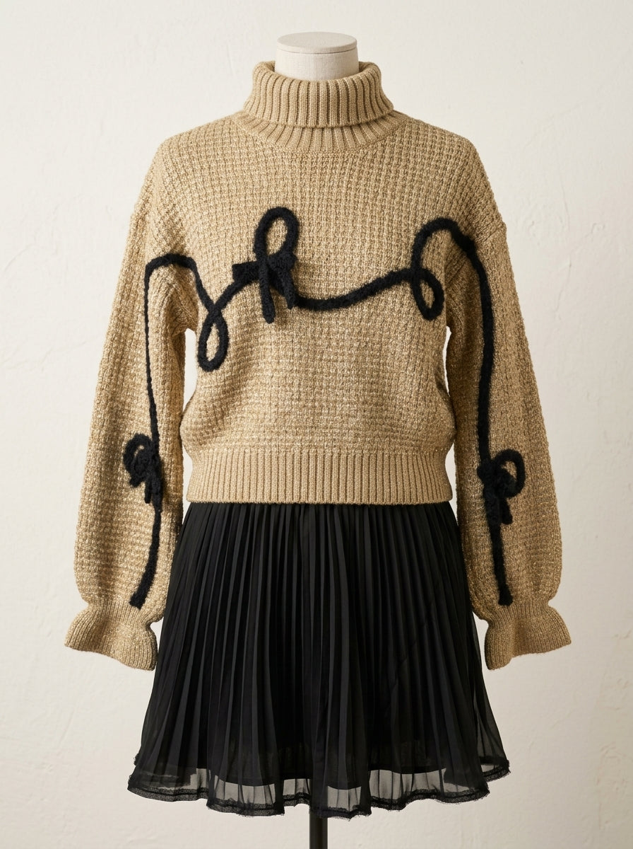Conjunto jersey marrón con detalles negros y falda plisada negra