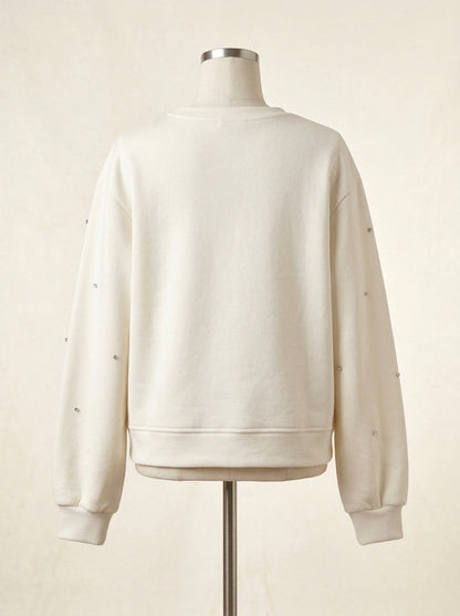 Sudadera color crudo con apliques brillantes